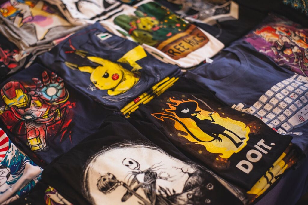 pexels-photo-2294342 A vibrant assortment of graphic t-shirts featuring popular characters displayed in a market setting.